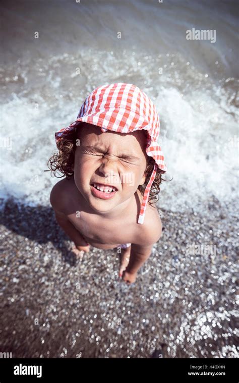 Little Kid Making Funny Face At The Beach Stock Photo Alamy