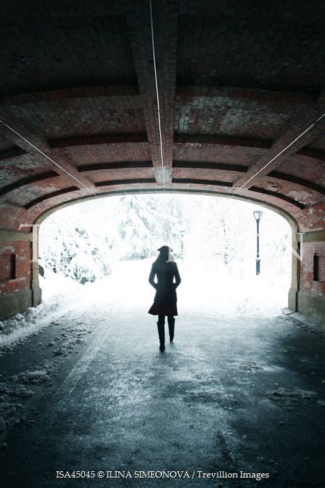 Trevillion Images Ilina Simeonova Woman Walking Through Tunnel In Snowy