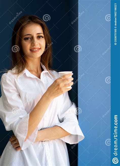 Portrait Of Brunette Woman With Dreamy Expression Smiles Pleasantly