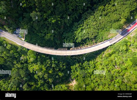 Aerial View Of Countryside Road Passing Through The Tropical Rainforest