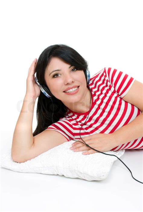Beautiful Girl Lying Down And Listening To Music Through Headphones