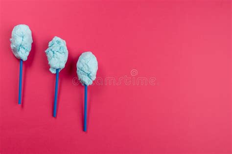 Horizontal Image Of Homemade Blue Candy Floss On Three Sticks On Pink