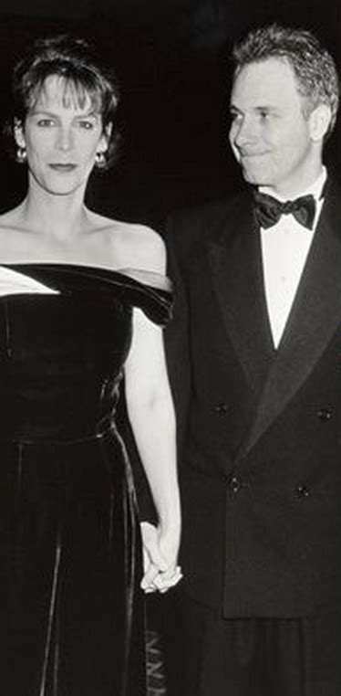 Two People In Formal Wear Standing Next To Each Other
