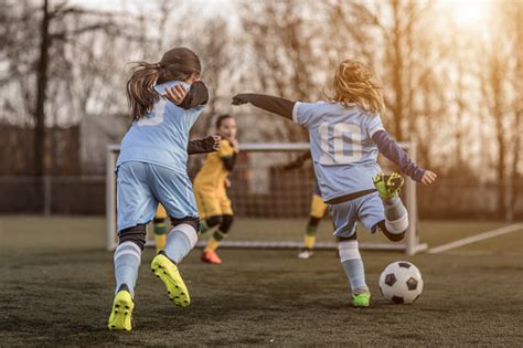 Two Female Girl Soccer Teams Playing A Football Training Match In The