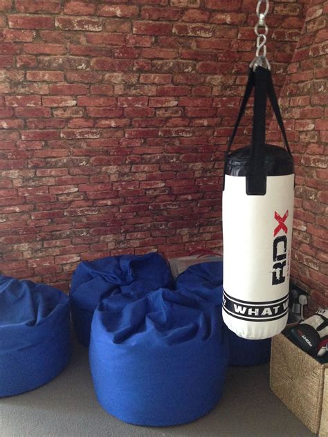 It adds warmth to the space and maintains a bright and open look. Boys room with punching bag and bean bags, brick wallpaper ...