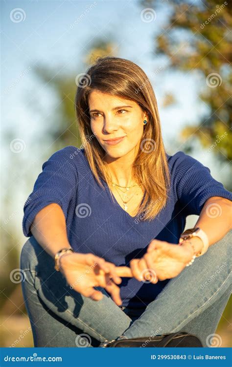 relaxed woman sitting outdoors in a park during sunset stock image image of focus wellbeing