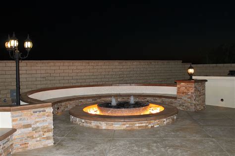 Water Fountain Fire Pit With Stamped Concrete Flooring And Split Face