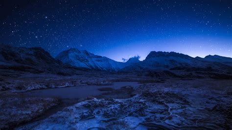Starry Night Sky Above The Snowy Mountains Wallpaper Backiee