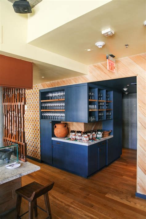 Iheart organizing my favorite tips for a deep pantry. A deep blue cabinet off the main dining room holds hand painted Mexican beverage pitch ...