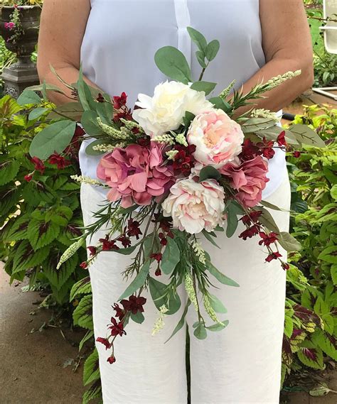 Although i'm going to ribbon wrap the handle of this particular bouquet, i can't resist showing you how to get those fabulous grass bouquet handles you see on. Mauve Blush Burgundy Cream Cascading Bridal Bouquet ...