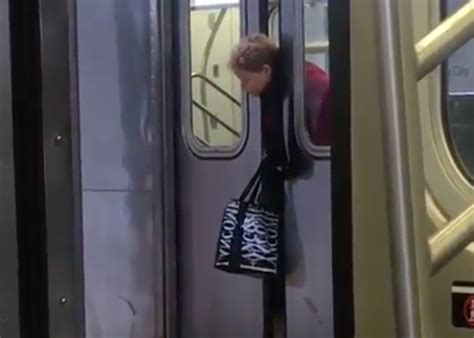 new york subway riders walk past woman with head trapped between doors video shows cbs news