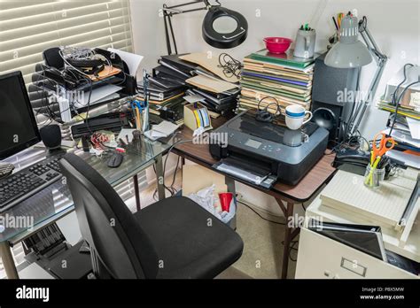 Messy Office Desk And Table With Piles Of Files And Disorganized