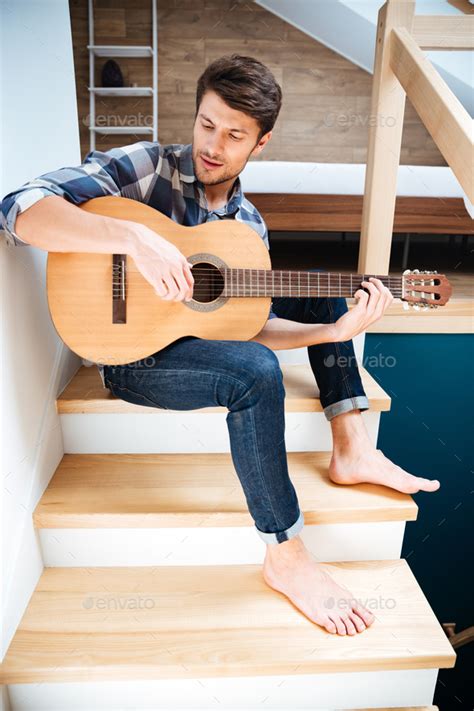 Man With Guitar Sitting Indoors Stock Photo By Vadymvdrobot Photodune