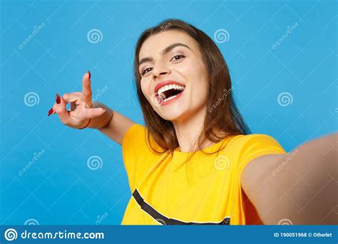 Close Up Selfie Shot Of Cheerful Cute Young Woman In Vivid Casual Clothes Looking Camera