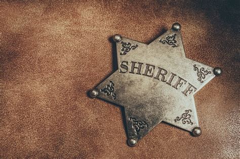 Sheriff Badge On Brown Leather Texture Background Stock Photo