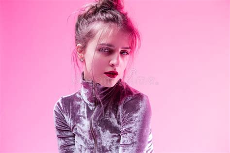 Portrait Of Sensual Tranqjuil Caucasian Girl In Gray Reflective Dress Posing Indoor On Pink