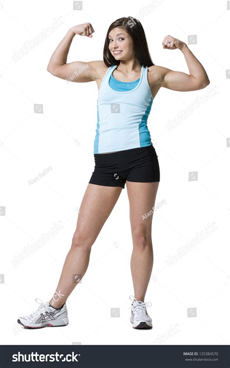 Female Athlete Flexing Biceps And Smiling Stock Photo 125384570