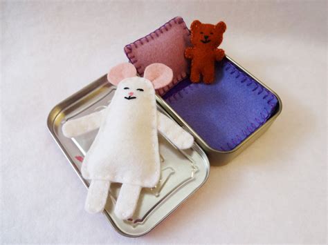 Two Small Tins With Stuffed Animals In Them