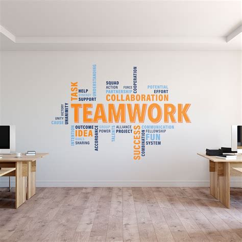 A Room With Two Desks And A Wall That Has The Word Teamwork Written On It