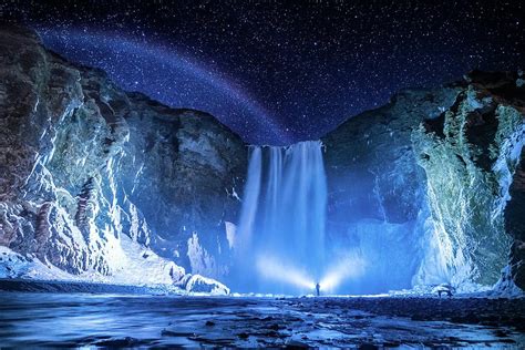 Person In Front Of Waterfalls During Nighttime Skogafoss Iceland