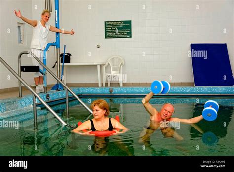 Physiotherapy Exercisessenior Couple And Therapist In The Gym Pool Of