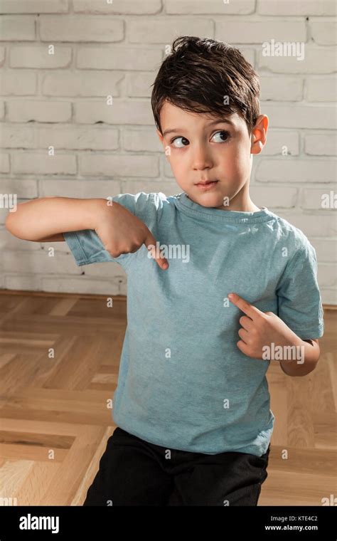 Happy Boy Pointing His Fingers On A Blank T Shirt Stock Photo Alamy