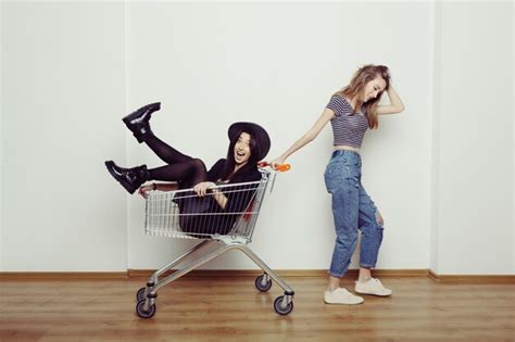 Premium Photo Two Happy Beautiful Teen Women Driving Shopping Cart