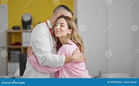 Man And Woman Doctor And Patient Hugging Each Other Smiling At The Clinic Stock Footage Video
