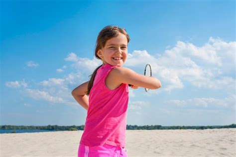 Premium Photo Outdoor Portrait Of Happy Girl Playing Beach Badminton