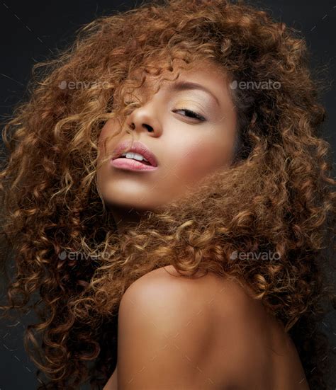 Beauty Portrait Of A Female Fashion Model With Curly Hair Stock Photo