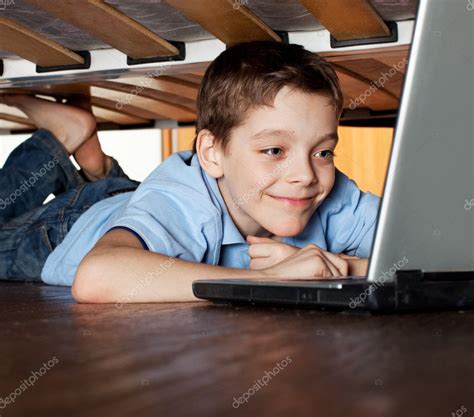 Child Playing Laptop Under The Bed Stock Photo By ©tatyanagl 9109159