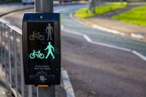 A Green Light On A Pedestrian Crossing Button Indicating That It Is