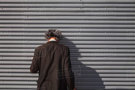 Senior Man Facing Wall With Head Downturned Stock Photo Dissolve