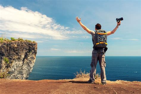 Travel Man Standing On The Top Mountain Cliff On Background Nature