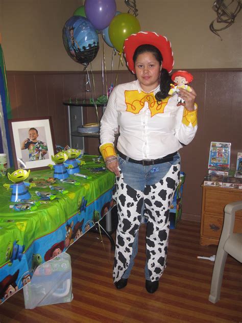 A Woman Wearing A Cowgirl Costume Standing In Front Of A Table With