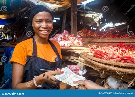 Young African Woman Selling Food Stuff In A Local African Market