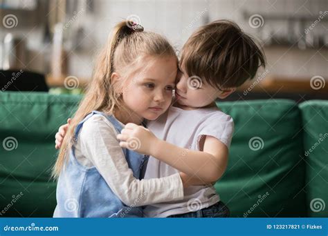 Little Boy Brother Consoling And Supporting Upset Girl Embracing Stock