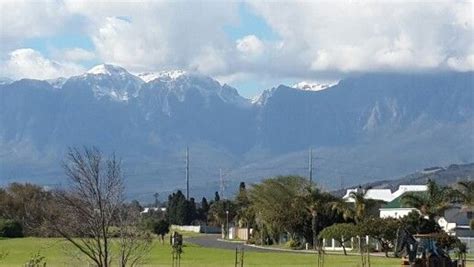 Hottentots Holland Mountain Range With Winter Snowcap Behind Strand