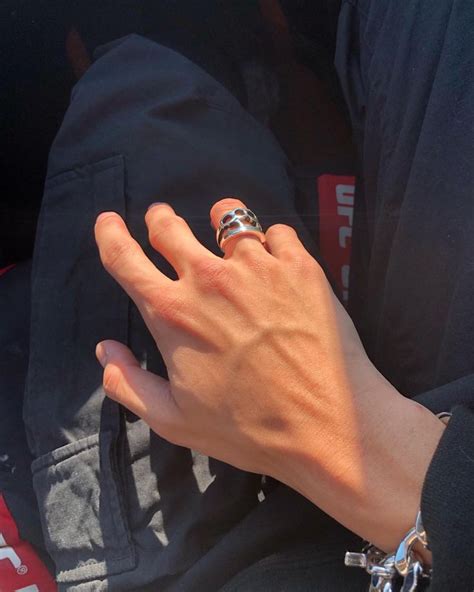 A Person S Hand With A Ring On It