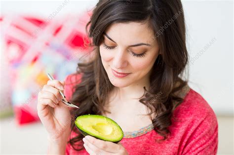 Woman Eating An Avocado Stock Image C0345996 Science Photo Library