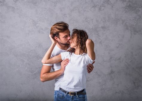 Young Man Hugging Woman From Behind Free Photo