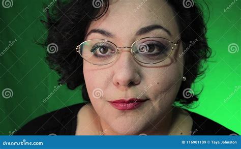 Mature Latina Woman Puts On Glasses With Green Background Stock Video Video Of Brown Latina