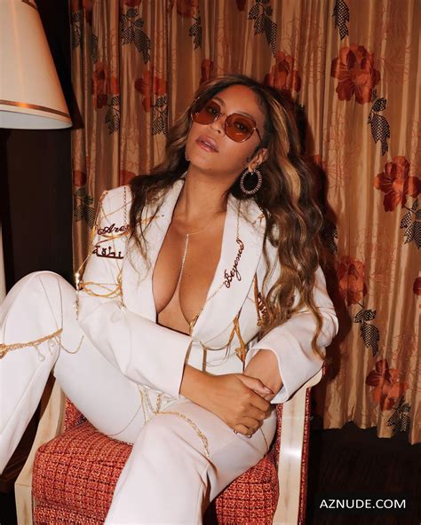 Beyonce Sexy Shows Off Her Cleavage Posing Braless In A White Pantsuit