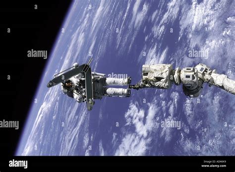 An Astronaut Is Anchored On The International Space Stations Canadarm2