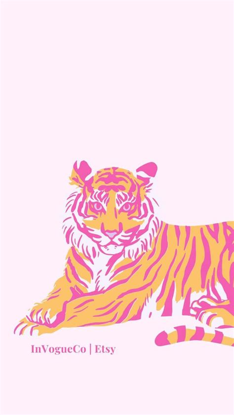 An Orange And Pink Tiger Laying Down On The Ground