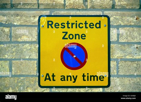 Restricted Zone Yellow Rectangular No Parking Street Sign Fixed On