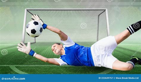 Composition Of Female Goalkeeper Catching Ball At Football Stadium