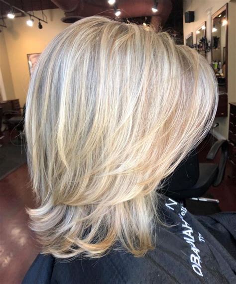 Above The Shoulder Feathered Blonde Haircut Medium Length Hair Cuts