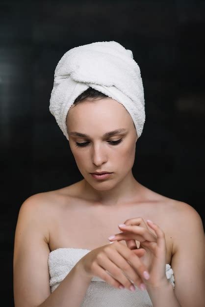 Premium Photo Face Cream Skin Care Beautiful Woman With A Towel On Her Head After Showering