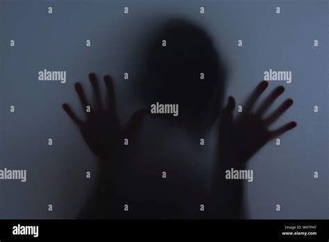 Shadowy Figure Behind Glass Fear Panic Concept Stock Photo Alamy